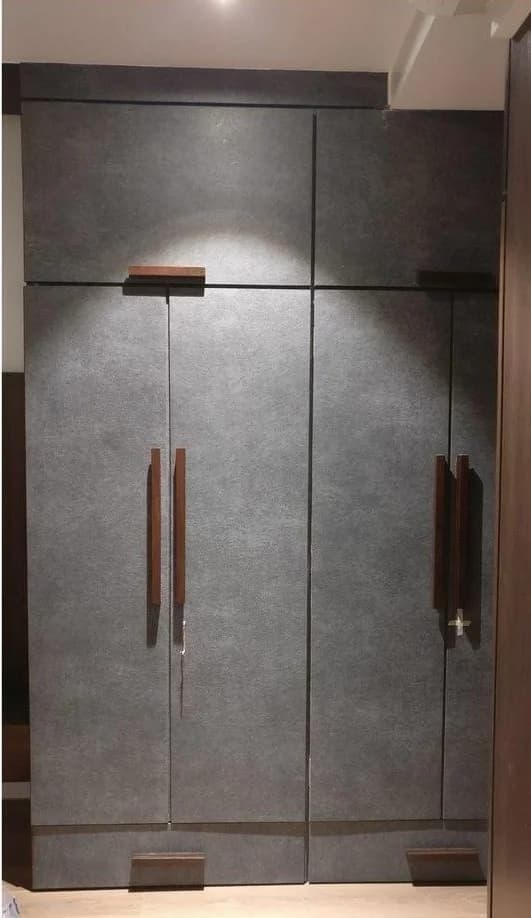 Modern gray wardrobe with wood handles and accents.