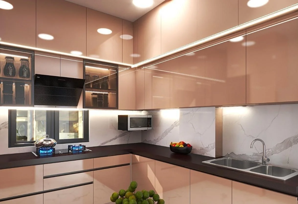 Modern rose gold kitchen with dark countertops and marble backsplash.