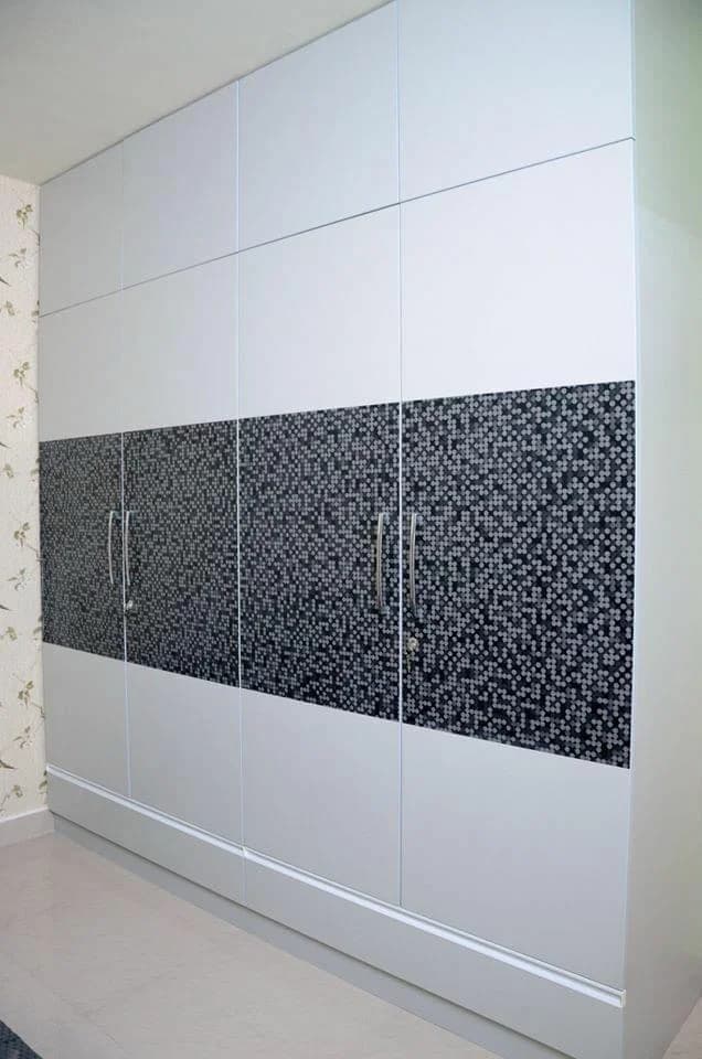 Modern white wardrobe with black and white tiled pattern.